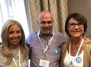 Two women and one man smiling